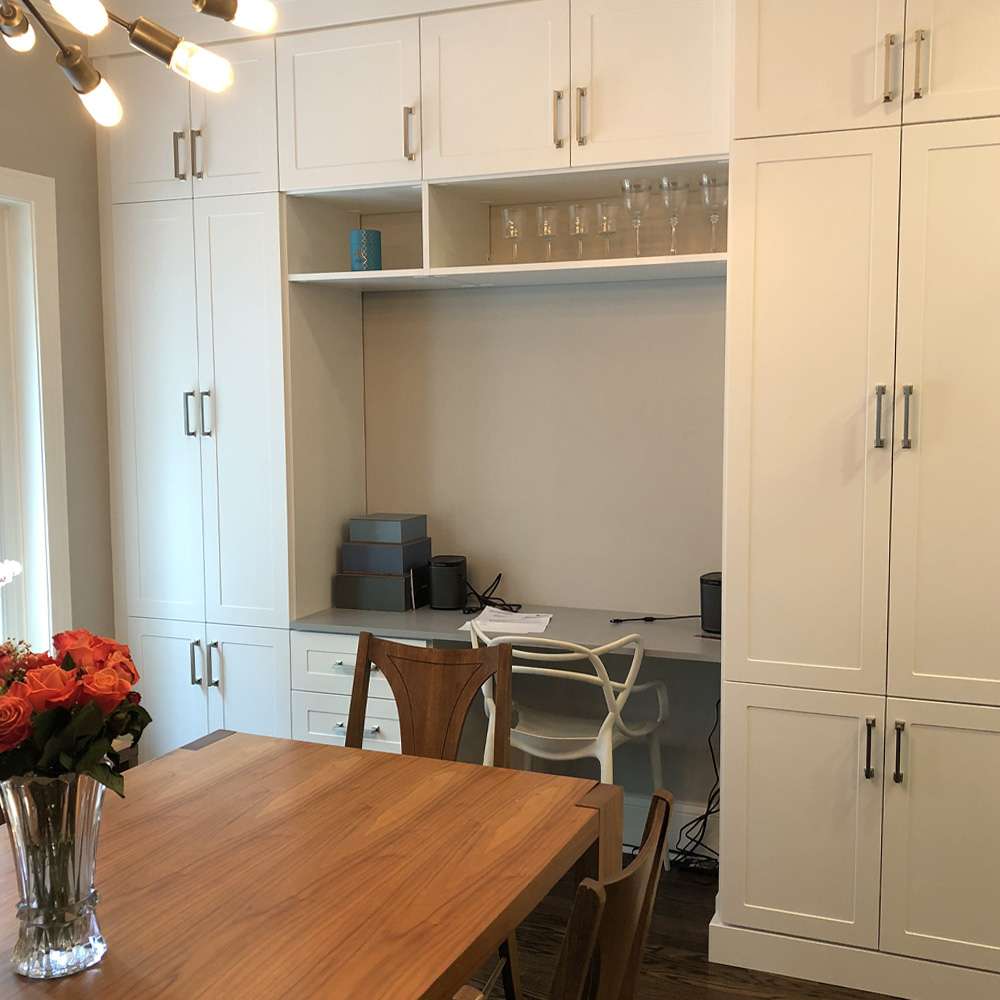 White melamine with Shaker fronts, sit down breakfast nook, and customer supplied handles
