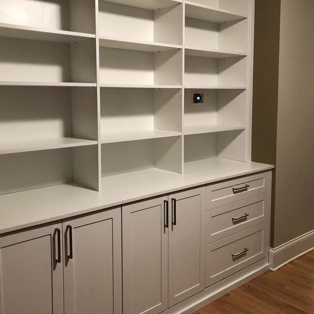 White melamine with Shaker fronts, 7 1/2” square handles, and bookcase area