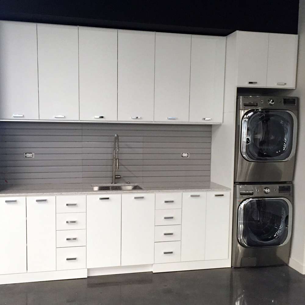 White melamine laundry room with Flat fronts and Chrome Metro handles
