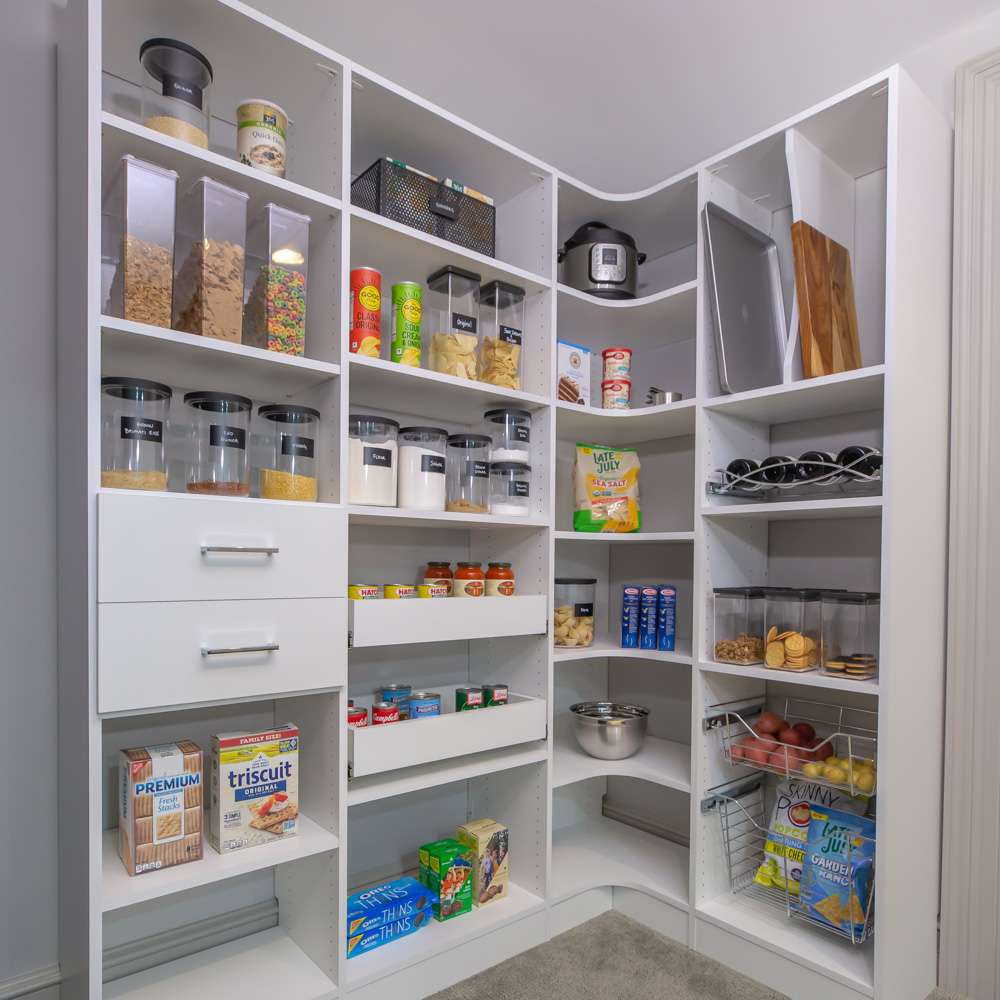 White pantry system with vertical tray dividers, radius corner shelves, and wine pull out